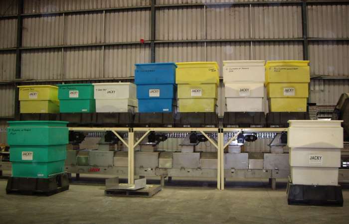 Discharging hopper bins in storage shed