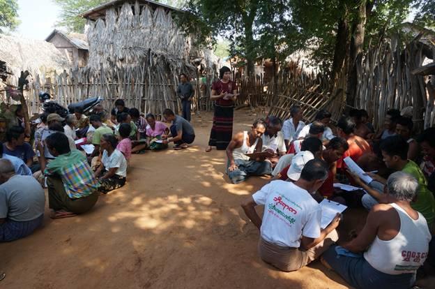 Villagers in Myanmar sitting around a talk being given on rainwater harvesting: Pic - Countercurrents org