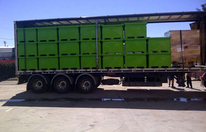 Truckload of green Procon Industrial Bins stacked