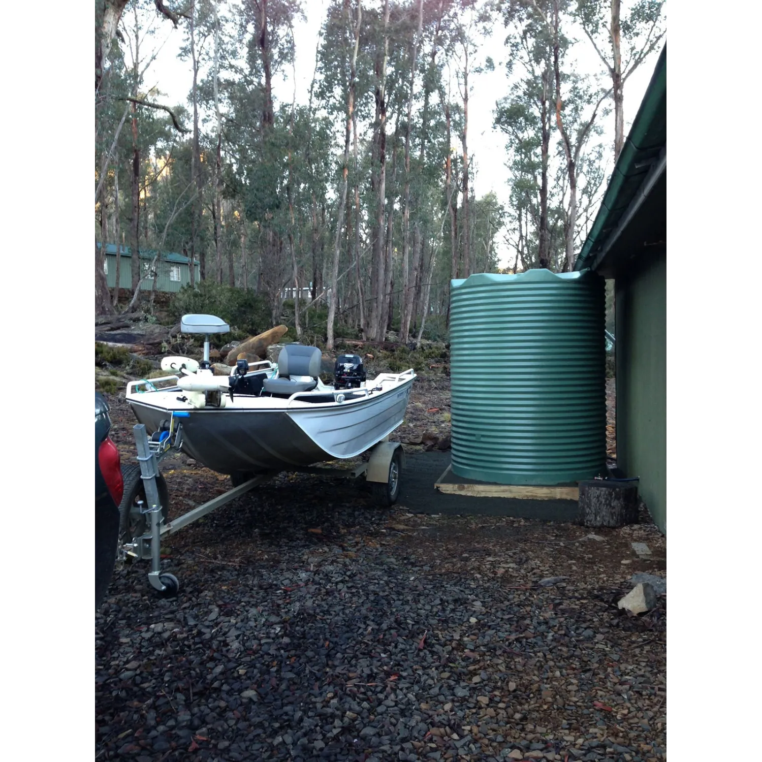 4600 Ltr Corrugated Rainwater Tank on fishing shack with boat