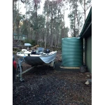 4600 Ltr Corrugated Rainwater Tank on fishing shack with boat