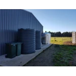 Two 4600 Ltr Corrugated Rainwater Tanks matching Colorbond® colours on a farm shed