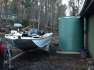 4600 Ltr Corrugated Rainwater Tank on fishing shack with boat