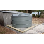 6300 Ltr Panelled Wall Rainwater Tank in Slate Grey next to garden shed with gravel and timber base