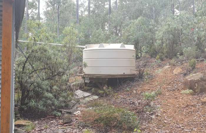 6300 Ltr Panelled Wall Rainwater Tank at Mt Barrow Tasmania on a raised timber based