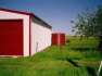 Red 11250 Ltr Corrugated Rainwater Tank matching shed colours on sheep farm