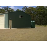 22000 Ltr Panelled Wall Rainwater Tank next to a green shed