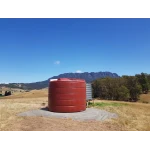 An Orion 22000 Ltr Panelled Wall Rainwater Tank next to steel water tank on open property