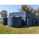 Two 22000 Ltr Panelled Wall Rainwater Tanks next to flat roof shed complemented by three smaller slimline tanks