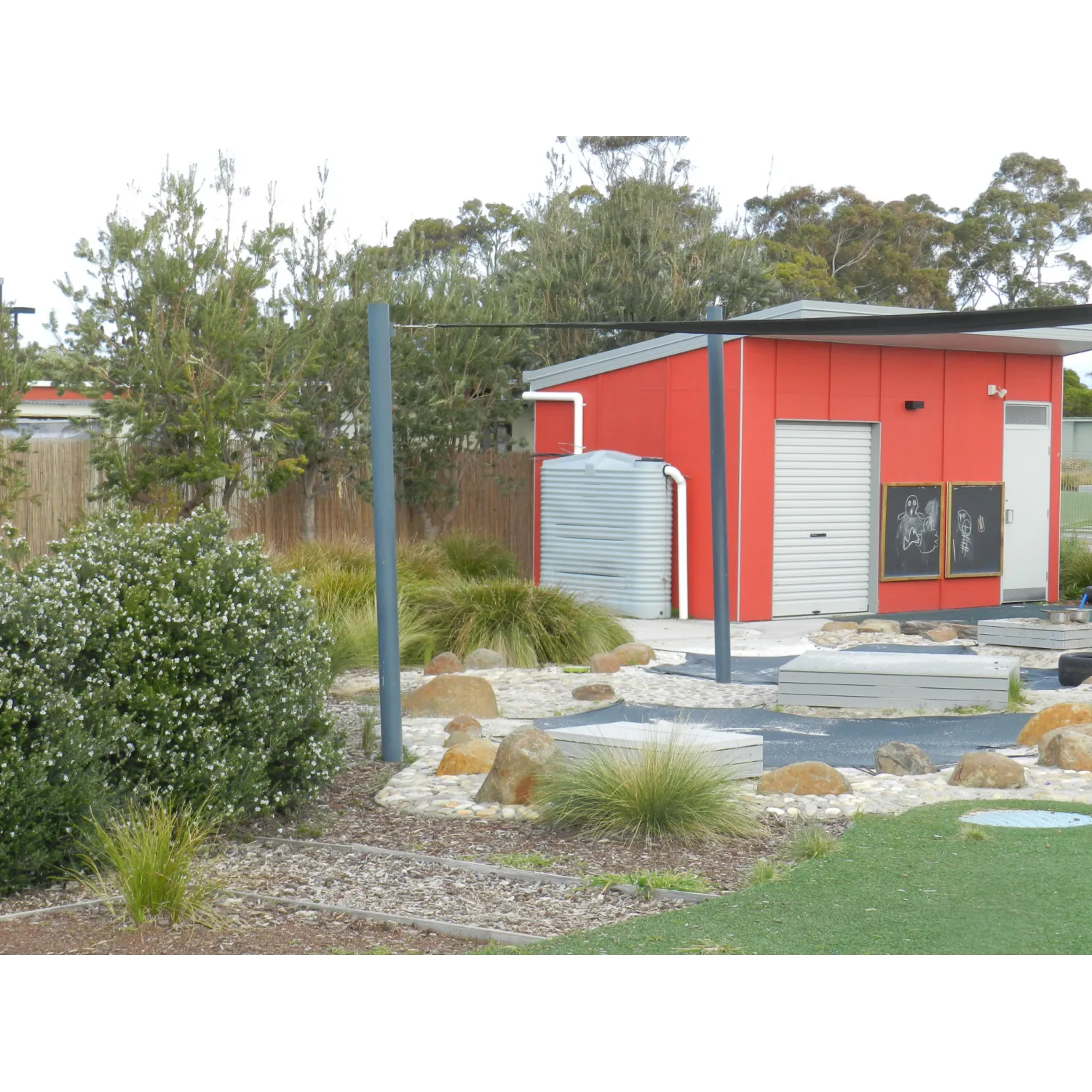 1000 Ltr Corrugated Slimline Tank on school shed next to play area
